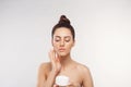 Beauty Woman Concept. Skin care. Young model with Soft skin holding cosmetic cream. Portrait of female applying moisturizing cream Royalty Free Stock Photo