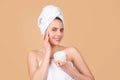 Beauty woman with cosmetic products clean healthy natural skin. Portrait of attractive young girl with a bath towel on Royalty Free Stock Photo