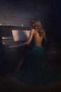 Beauty woman in evening dress playing piano Royalty Free Stock Photo
