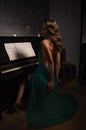 Beauty woman in evening dress playing piano Royalty Free Stock Photo