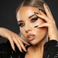 Beauty Woman with Eye liner Makeup and Black Nails Manicure. Luxury Model Face with Full Lips Make up. Beautiful Female Close up Royalty Free Stock Photo