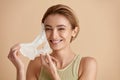 Beauty Woman Face Mask. Portrait Of Beautiful Girl Removing Sheet Mask Royalty Free Stock Photo