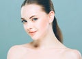 Beauty Woman face Portrait. Beautiful Spa model Girl with Perfect Fresh Clean Skin. Blue background. Royalty Free Stock Photo