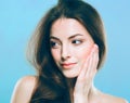 Beauty Woman face Portrait. Beautiful Spa model Girl with Perfect Fresh Clean Skin. Blue background gray Royalty Free Stock Photo