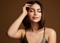 Beauty Woman Face Portrait over Dark Brown. Fashion Model with Perfect Skin Make up and Bob Hairstyle. Dreamy Stylish Girl Royalty Free Stock Photo