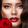 Beauty Woman Face Red Lipstick Portrait with Rose. Fashion Model Girl Red Lips Make up. Luxury Skin Care Cosmetic and Makeup Royalty Free Stock Photo