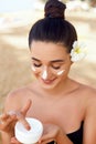 Beauty Woman Face Skin Care. Portrait Of Attractive Young Female Applying Cream And Holding Bottle. Closeup Of Smiling Girl With N Royalty Free Stock Photo