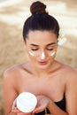 Beauty Woman Face Skin Care. Portrait Of Attractive Young Female Applying Cream And Holding Bottle. Closeup Of Smiling Girl With N Royalty Free Stock Photo