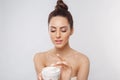 Beauty Woman Face Skin Care. Portrait Of Attractive Young Female Applying Cream And Holding Bottle. Closeup Of Smiling Girl With N Royalty Free Stock Photo