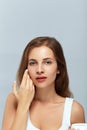 Beauty woman Facial Care. Female Applying Cream. Beauty Face. Portrait Of Young Woman. CloseUp Of Beautiful Girl With Beauty Prod