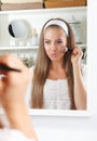 Beauty woman fixing her makeup in the mirror Royalty Free Stock Photo