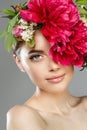 Beauty woman with flowers on head. Happy beautiful girl on gray banner background. Pretty model with clear skin. Spring fashion Royalty Free Stock Photo