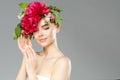 Beauty woman with flowers on head. Happy beautiful girl on gray banner background. Pretty model with clear skin. Spring fashion Royalty Free Stock Photo