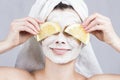 Beauty woman getting facial mask. Attractive young woman with fruit mask on face at spa salon. Royalty Free Stock Photo
