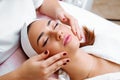 Cosmetic massage, facial treatment. Royalty Free Stock Photo