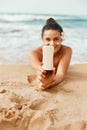 Beauty Woman holding bottles of sunscreen in her hands. Royalty Free Stock Photo