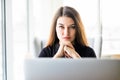 Beauty woman with laptop in front look at camera in office Royalty Free Stock Photo