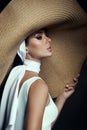 Beauty woman in a large wicker hat and light summer dress. Smokey makeup, perfect portrait of a woman