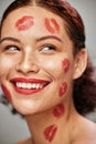 Beauty woman, lipstick kiss and happy face of makeup model in studio for cosmetics and love. Headshot of aesthetic