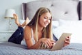 Beauty woman lying on the bed with tablet Royalty Free Stock Photo