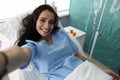 Beauty woman make selfie photo in hospital ward portrait