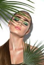 Beauty Woman with natural green palm leaf Portrait, model girl with perfect makeup, green eyeshadows Royalty Free Stock Photo