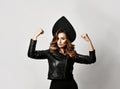 Beauty woman in new modern fashion leather jacket and Russian style kokoshnik hat on gray Royalty Free Stock Photo