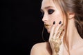 Beauty Woman Portrait. Professional Makeup and Manicure with gold foil glitter, smokey eyes. Black colors. Copy-space Royalty Free Stock Photo