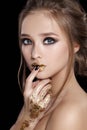 Beauty Woman Portrait. Professional Makeup and Manicure with gold foil glitter, smokey eyes. Black colors. Copy-space Royalty Free Stock Photo