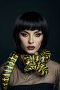 Beauty woman short haircut python yellow snake on her neck. A yellow snake on the shoulders of a girl. Beauty yellow eye shadow