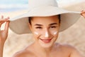 Beauty Woman smile applying sun cream on face. Skincare. Body Sun protection