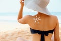 Beauty Woman with sun shaped sunscreen on her back. Skin care. Royalty Free Stock Photo