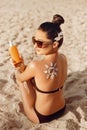 Beauty Woman With Suntan Lotion At The Beach In Form Of The Sun. Portrait Of Female With the Drawn Sun On a Shoulder On The Beach Royalty Free Stock Photo