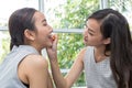 Beauty woman take lipstick, Girl friends helping with make-up. Girlfriends fooling around with makeup. Two smiling woman applying Royalty Free Stock Photo