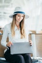 Beauty woman using laptop with suitcase while waiting for take off flight. Woman sitting in airport terminal. People and Royalty Free Stock Photo