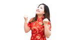 Beauty woman wear cheongsam and feel excited with chinese new year on white background. She wears bracelets, gold rings and flower