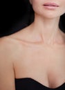 Beauty women lips nude makeup, beautiful neck and neckline, clean skin on black background Royalty Free Stock Photo