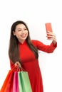 Beauty women wear aodai selfie while hold shopping bags in lunar new year