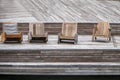 Beauty in Wood - Assorted comfy wooden chairs sit on a wooden deck at waterside