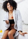 Beauty young african american woman in bathrobe with tooth brush taking morning care of herself, lifestyle concept Royalty Free Stock Photo