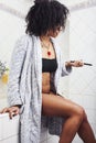 beauty young african american woman in bathrobe with tooth brush taking morning care of herself, lifestyle people Royalty Free Stock Photo