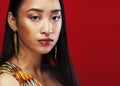 Beauty young asian girl with fashion make up on red background , beauty stylish look