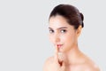 Beauty young asian woman gesture finger on mouth showing hush quiet and secret about skin care on face isolated.