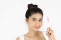 Beauty young Asian woman holding makeup brushes over white  background. Healthy and cosmetics concept Royalty Free Stock Photo