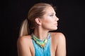 Beauty young blonde woman portrait with large blue necklace with