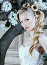 Beauty young bride alone in luxury vintage interior with a lot of flowers close up, bridal style