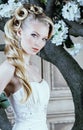 Beauty young bride alone in luxury vintage interior with a lot of flowers close up, bridal style