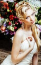 Beauty young bride alone in luxury vintage interior with a lot of flowers close up