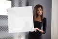 Good looking young business lady in black strong suite hold empty paper Royalty Free Stock Photo