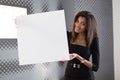 Good looking young business lady in black strong suite hold empty paper Royalty Free Stock Photo